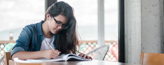 Female student writing in her notebook
