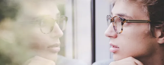 Student thinking while looking out the window